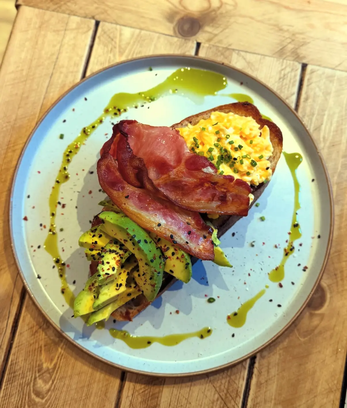 Bacon, scrambled eggs and avocado on toasted sourdough
