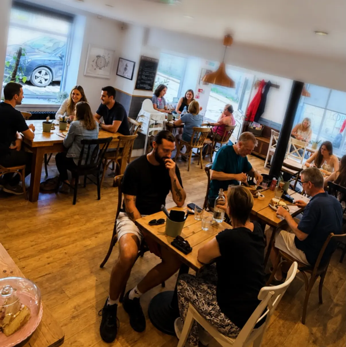 Customers chatting over food and drinks inside The Green