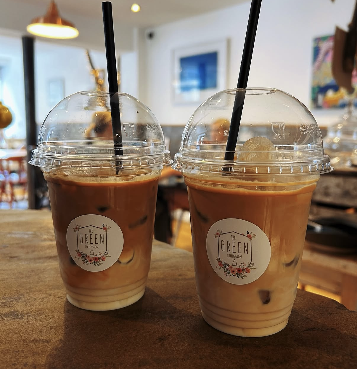 Two iced coffees to take away in cups with The Green's logo