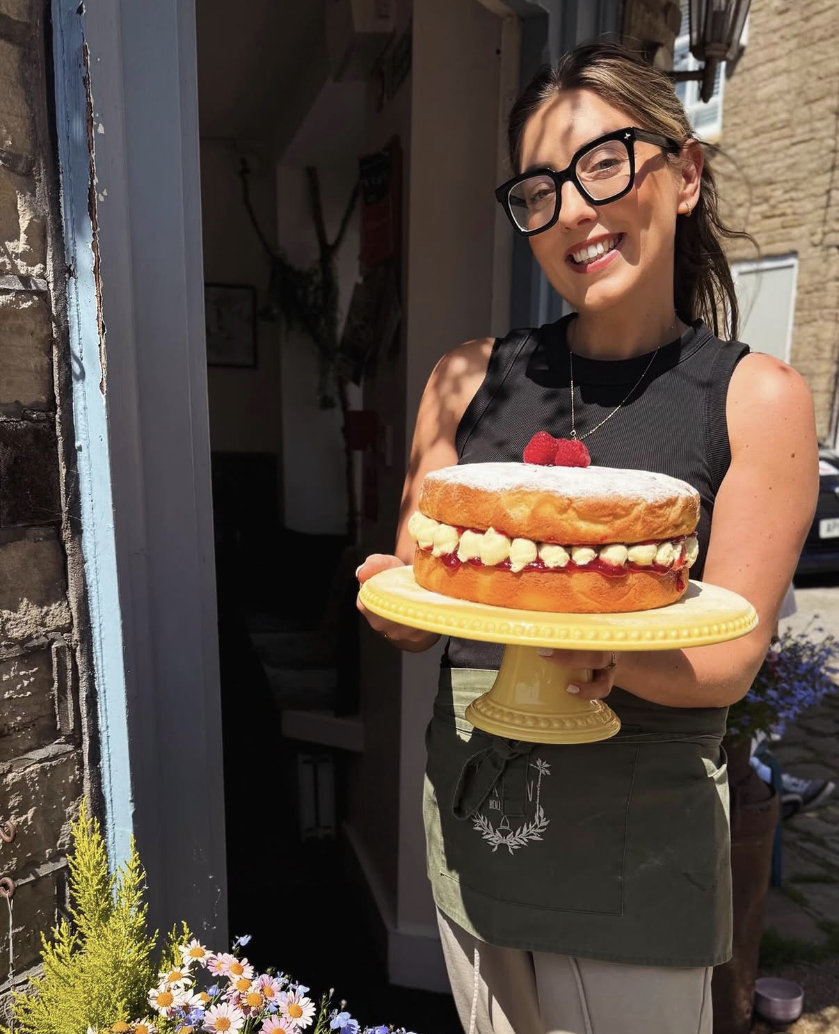 A homemade Victoria sponge held at The Green's front door